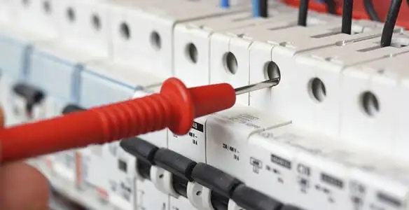 Electrical contractor testing circuit breakers during electrical repair in Lynwood, CA