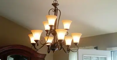 Classic ceiling chandelier installation with warm lighting in Los Angeles, CA