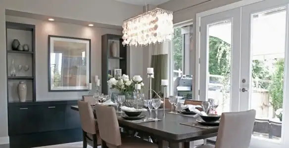 Elegant dining room chandelier installation above table in Los Angeles, CA