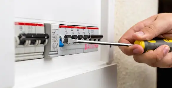 electrical panel upgrade service showing technician adjusting circuit breakers during system upgrade in Los Angeles, CA
