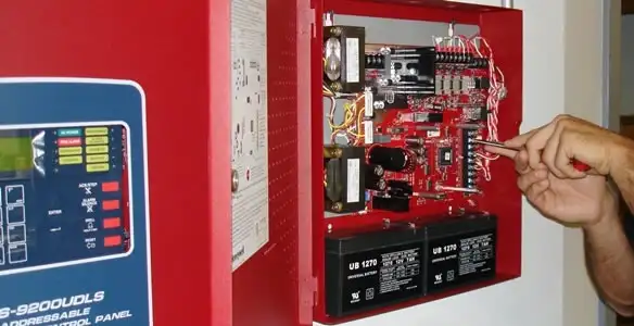 fire alarm installation service showing technician configuring fire alarm control panel in Los Angeles, CA