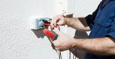 Electrician performing home electrical outlet and wiring inspection in Los Angeles, CA