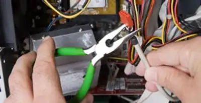 Licensed electrical contractor performing electrical repair with tools in Lynwood, CA