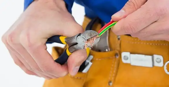 licensed electrician securing electrical wiring with professional tools during service work in Los Angeles, CA