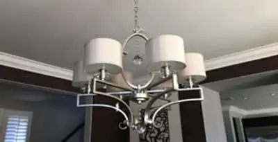 Modern chandelier installation with multiple light fixtures in Los Angeles, CA