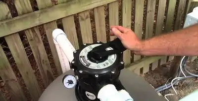 pool pumps service showing professional adjustment of pool pump control system in Los Angeles, CA